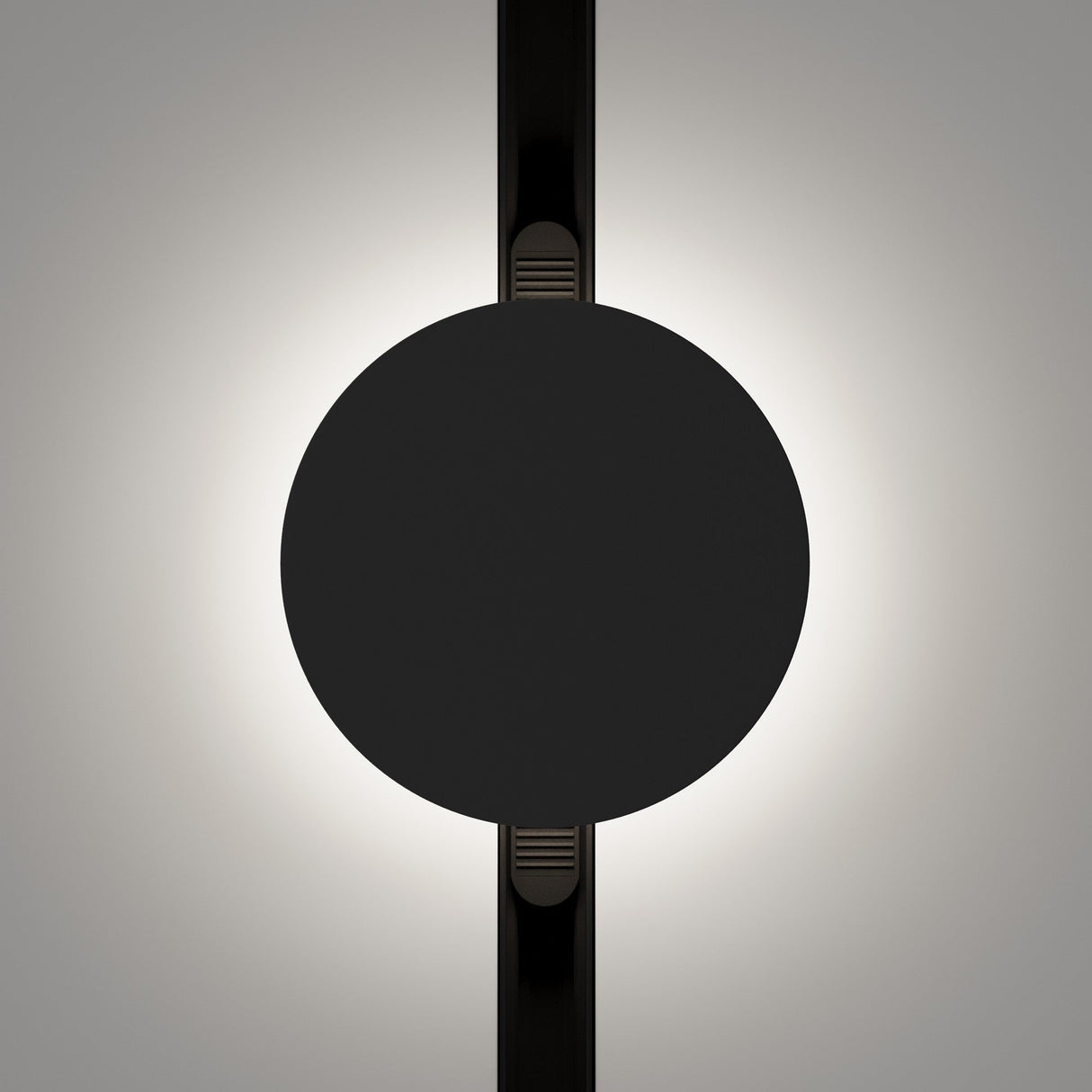 The Relax CCT LED Dimmable Magnetic Exility Track Wall/Ceiling Light 5W features a sleek, futuristic design with a central black circle and illuminated edges creating a halo effect. It includes vertical black lines on a greyish background, epitomizing modern design.