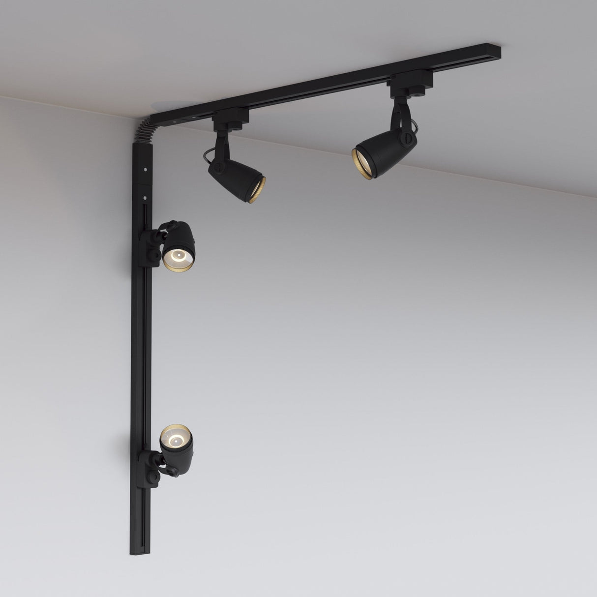 The Unity Single Phase Surface-Mounted Track in black features a minimalist, modern design with three adjustable spotlights forming an L-shape on a white ceiling, offering easy adjustments through its flexible connector.