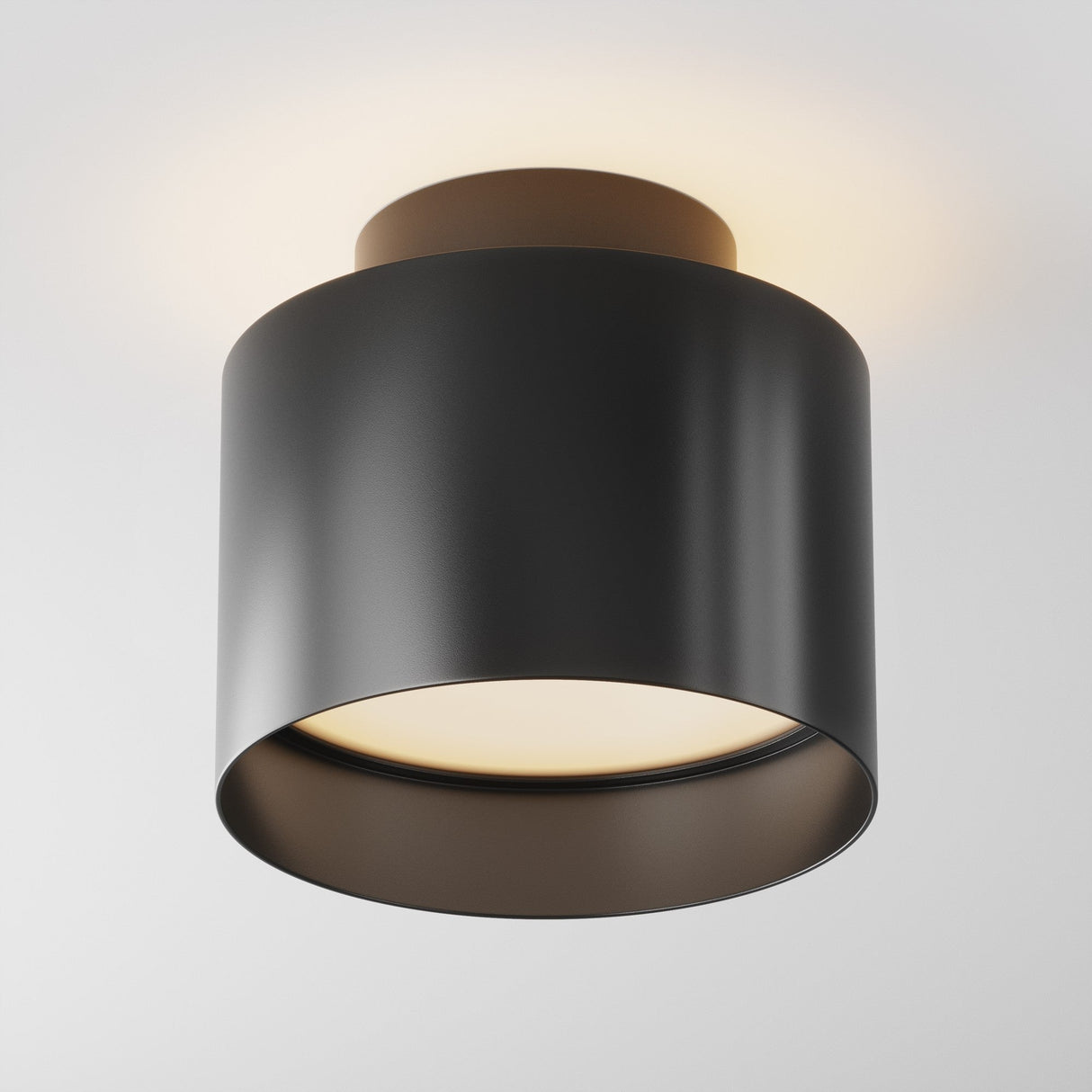 The Planet LED Small Round Surface Downlight 3000K in black elegantly emits a warm glow from both the top and bottom, highlighted against a simple white background.