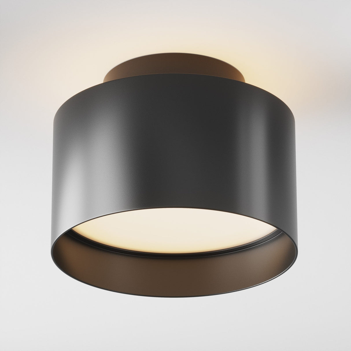 The Planet LED Medium Round Surface Downlight 3000K in black is a modern, cylindrical ceiling lamp featuring an energy-efficient LED design. It has a reflective inner surface and emits warm white light upward, creating a cozy atmosphere with its minimalist style.