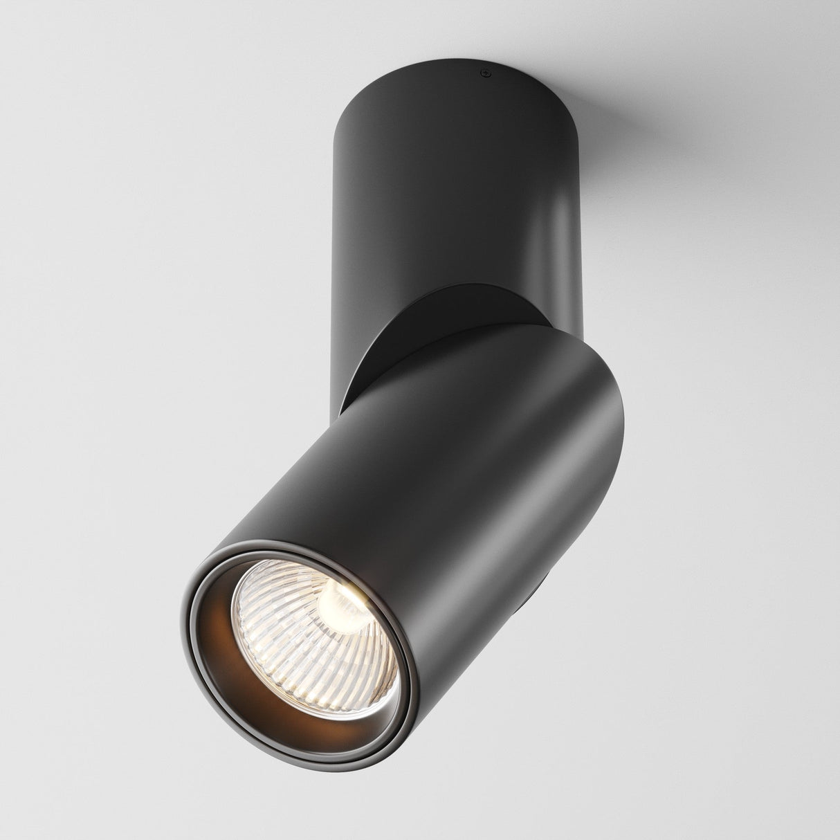 The Dafne LED Single Spotlight 10W 3000K in black, with its cylindrical shape and sleek modern design, provides energy-efficient illumination. The ceiling-mounted spotlight features a smooth finish and is angled downward for optimal lighting against a plain white background.