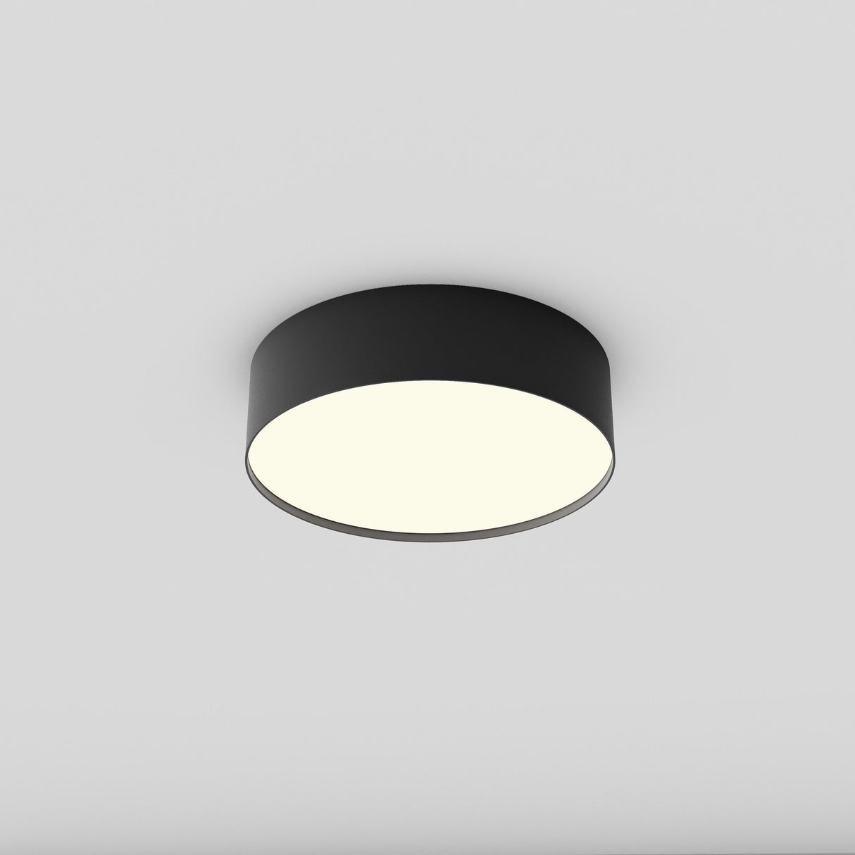 The Zon LED Flush Ceiling Light 3000K 24W - Black features a sleek, circular design with a wide black rim. It emits bright, white light for an even ceiling glow, boasting minimalistic and contemporary style while being energy-efficient for any home.