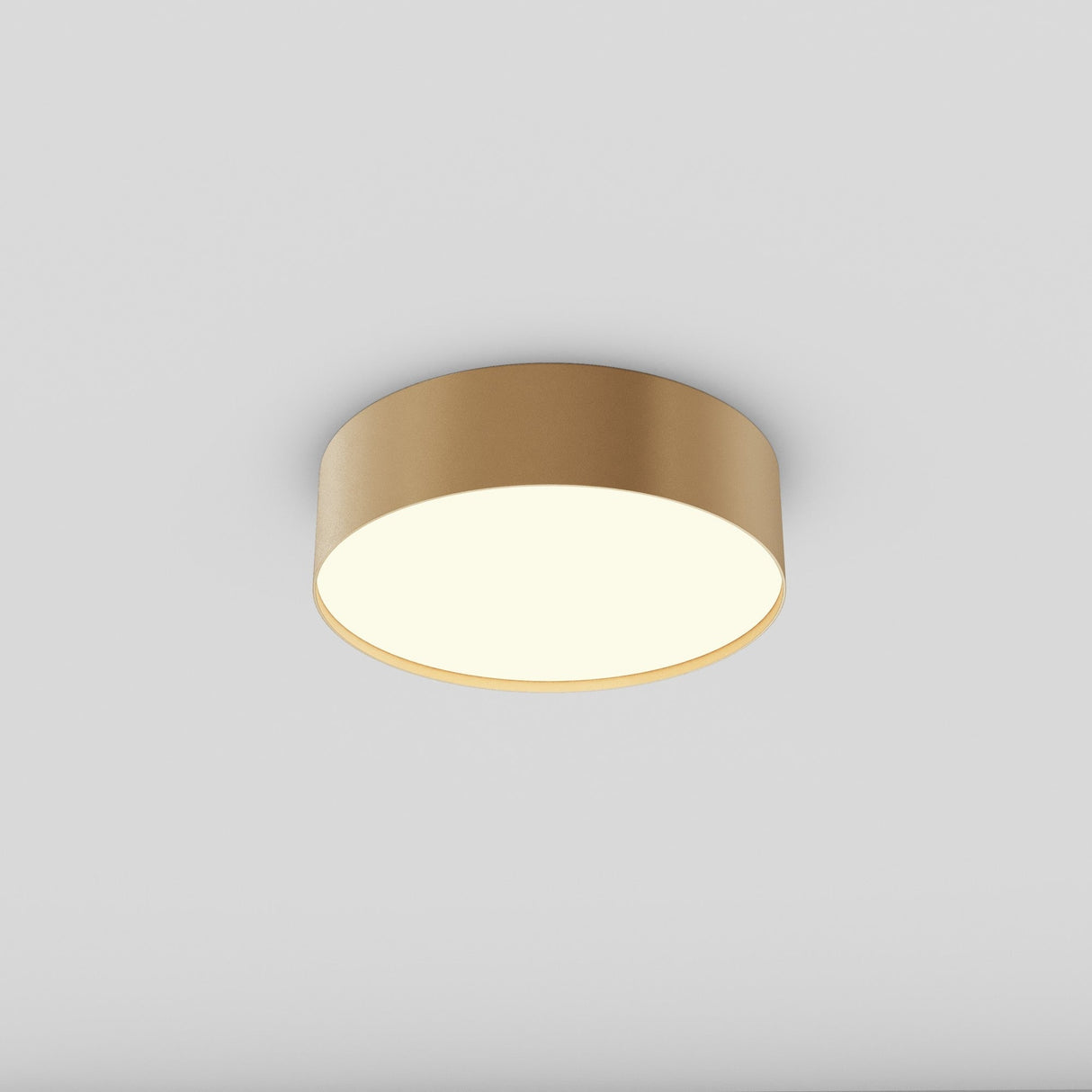The Zon LED Flush Ceiling Light in matte gold casts a soft white glow (3000K) against a plain white background, highlighting its energy-efficient 24W design.