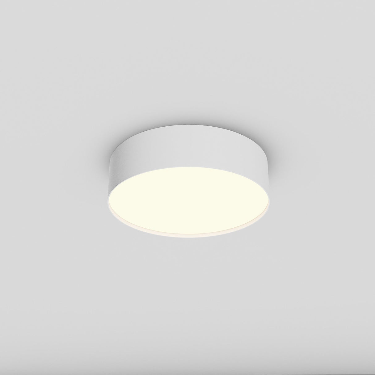 The Zon LED Flush Ceiling Light 3000K 26W - White is installed on a simple white ceiling, offering an energy-efficient, soft warm glow that gently contrasts with the surroundings.