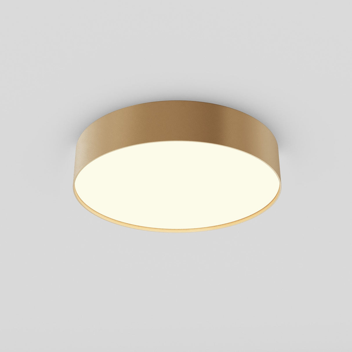 The Zon LED Flush Ceiling Light 3000K 36W - Matte Gold showcases a sleek, minimalist design with an energy-efficient matte gold rim encircling a bright, white surface, emitting soft, even illumination against a plain light gray background.