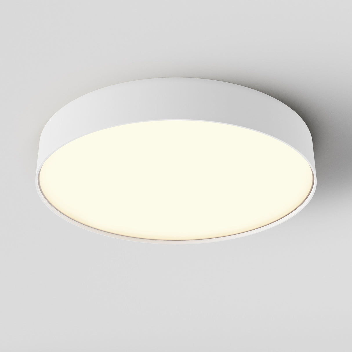 The Zon LED Medium Flush Ceiling Light, 3000K 45W, features a circular white frame and modern minimalist design that blends seamlessly into your ceiling with its soft, glowing surface.