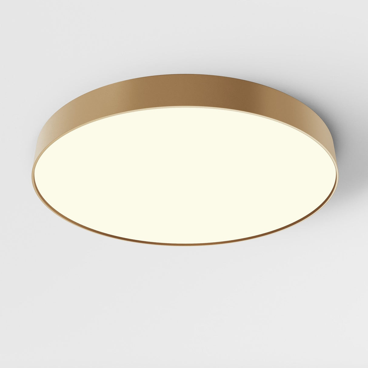 The Zon LED Large Flush Ceiling Light 3000K 90W - Matte Gold showcases a round, flush-mount design with a matte gold rim and smooth white diffuser, offering even light distribution. Its modern minimalist style enhances any white ceiling.