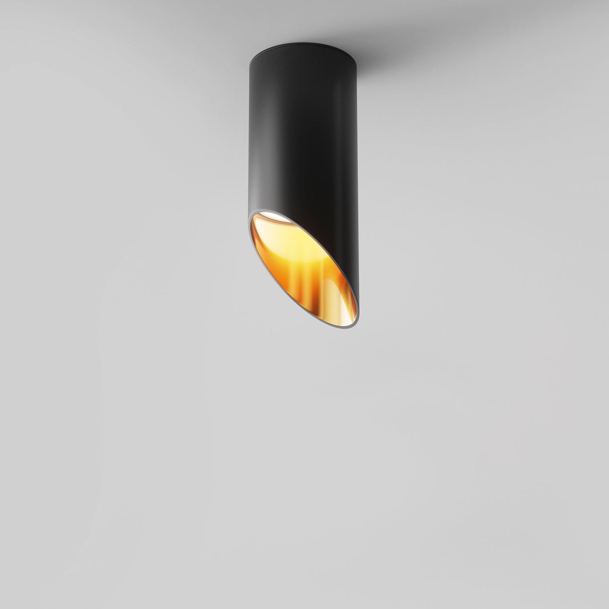 The Lipari Short Surface Mounted Downlight 15cm - Black & Gold adds sophistication to any room with its sleek cylindrical design, casting a soft glow on white ceilings as elegant accent lighting.