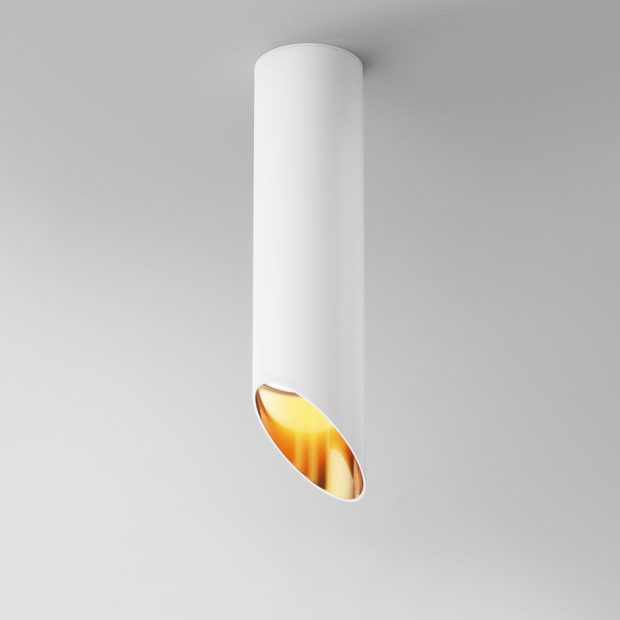 The Lipari Long Surface Mounted Downlight 25cm in White & Gold is a modern cylindrical ceiling fixture with an angled opening, revealing a warm glow and minimalist luxury lighting through its white exterior and gold interior design.