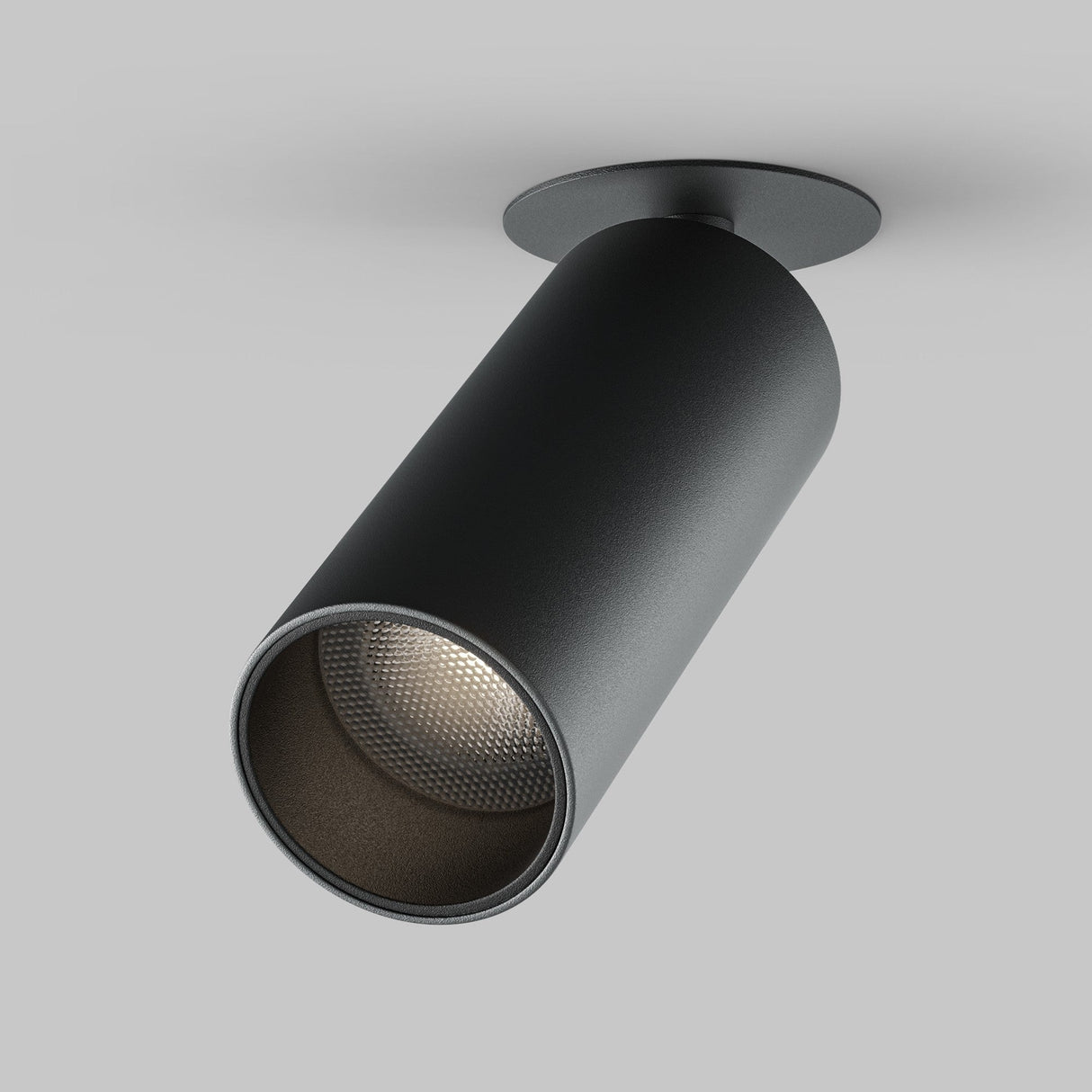 The Focus LED Single Recessed Spotlight 12W 4000K in black, featuring a sleek cylindrical design with a matte finish and textured interior, is mounted against a gray background, highlighting its modern angled style.