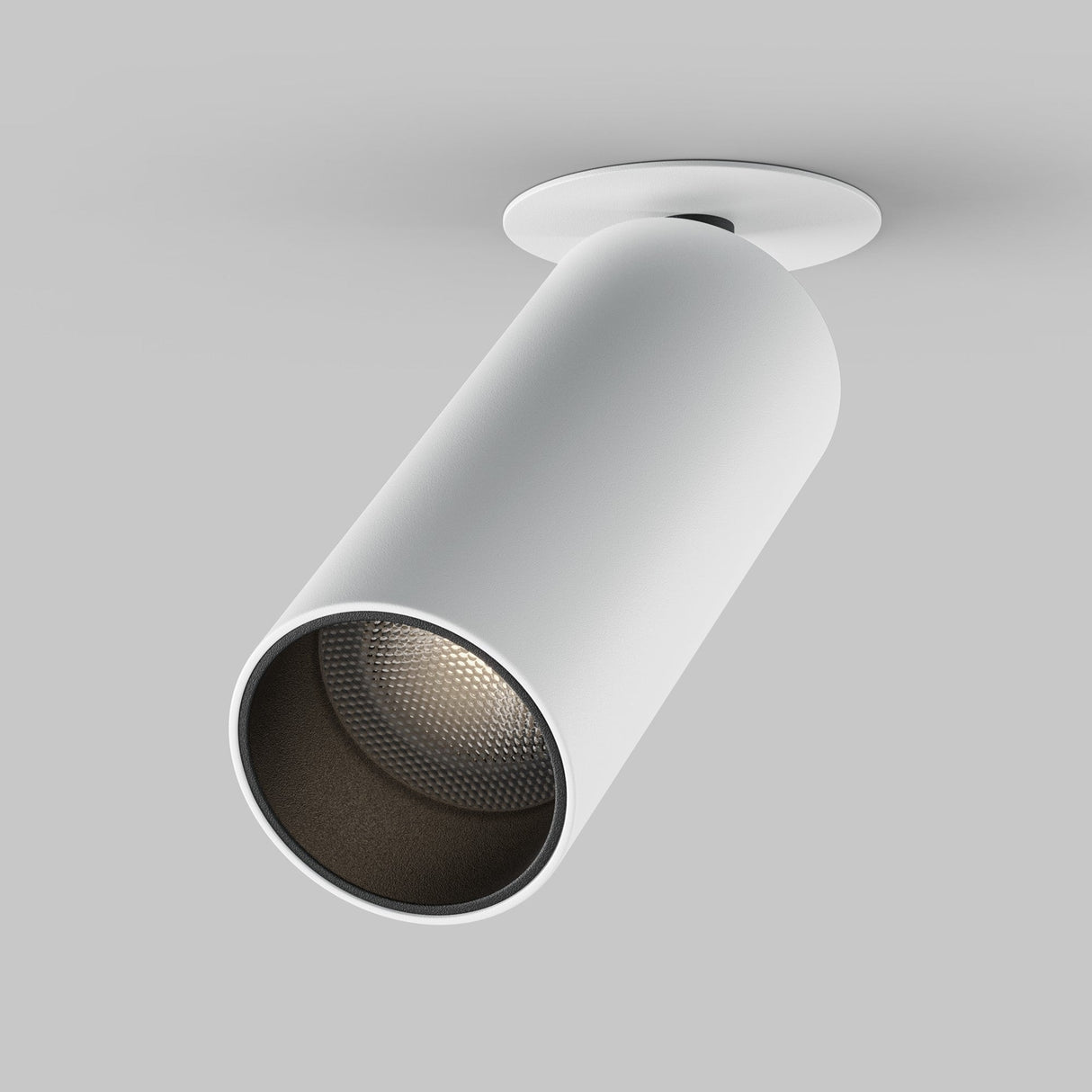 The Focus LED Single Recessed Spotlight 12W 4000K - White is a sleek, cylindrical spotlight mounted on the ceiling. Its minimalist design features a modern recessed style with an energy-efficient touch and a textured interior visible at the opening, angled slightly downward.