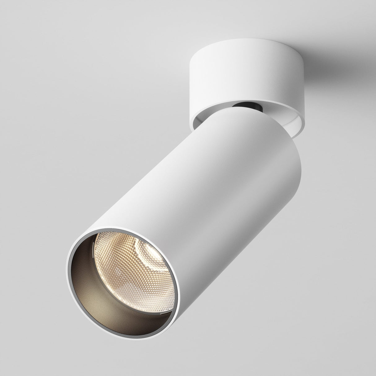 The Focus LED Dimmable Single Spotlight 12W 3000K in white is a modern, energy-efficient cylindrical ceiling fixture that emits a bright glow when turned on, contrasting with the plain white ceiling.