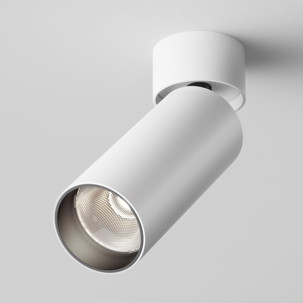 The Focus LED Single Surface-Mounted Spotlight 12W 4000K in white boasts a modern cylindrical design with an open front revealing the bulb, attached to the ceiling with a round base. It casts energy-efficient lighting downwards, ideal for contemporary interiors.