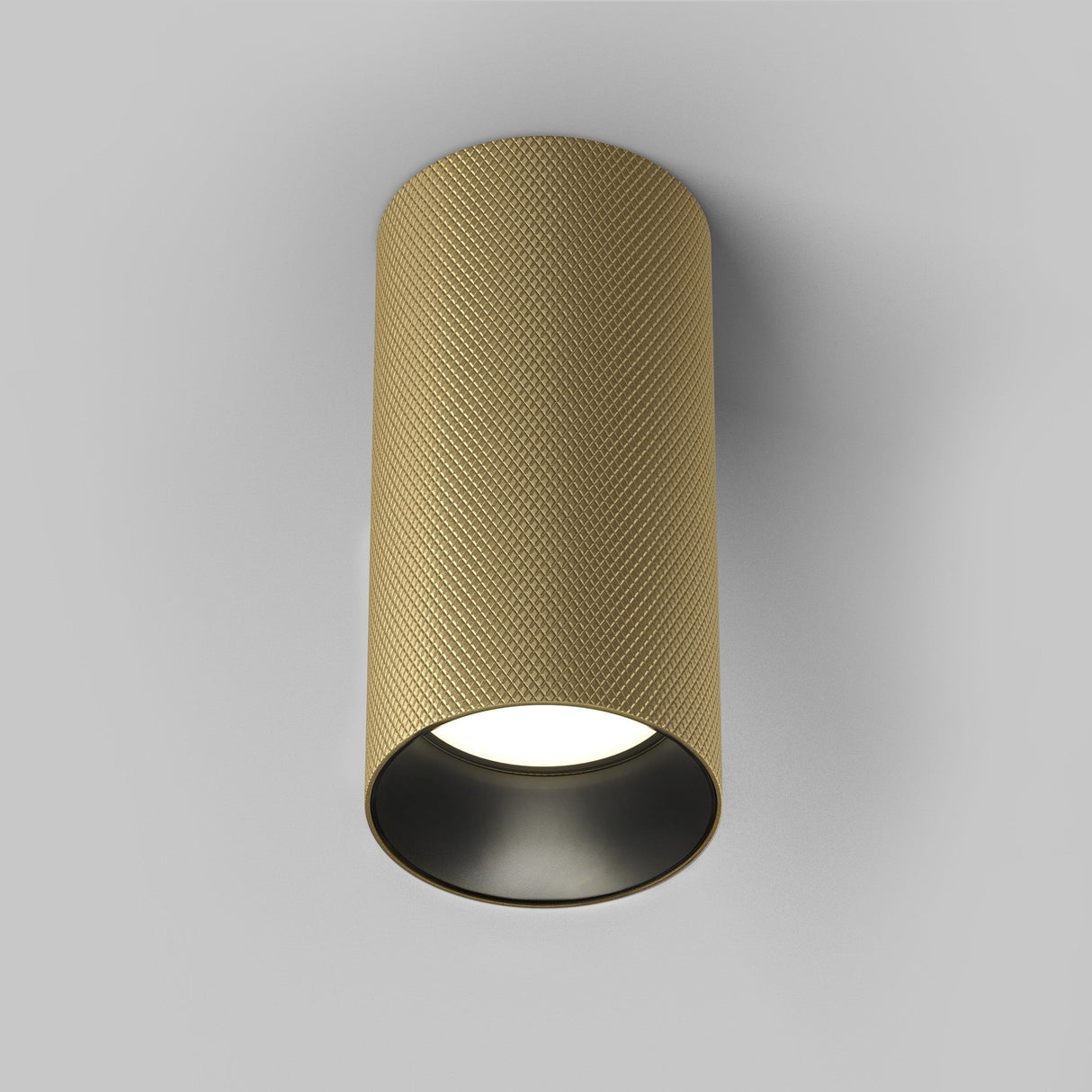 The Artisan Single Fixed Round Surface Mounted Downlight in matte gold is a luxury lighting piece with a textured exterior and smooth black interior, seamlessly mounted on a white ceiling to illuminate downward.