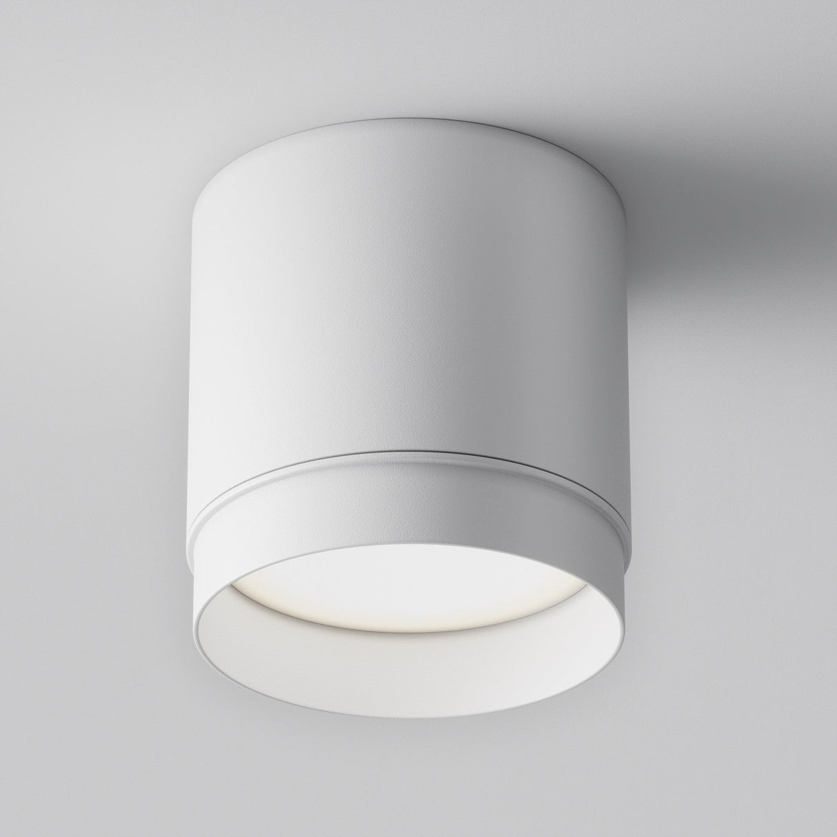 Discover the versatile Polar Round Surface Downlight in white, a modern cylindrical ceiling fixture with a minimalist design. It mounts directly on your ceiling, featuring an open bottom that emits soft, diffused light to enhance any space beautifully.