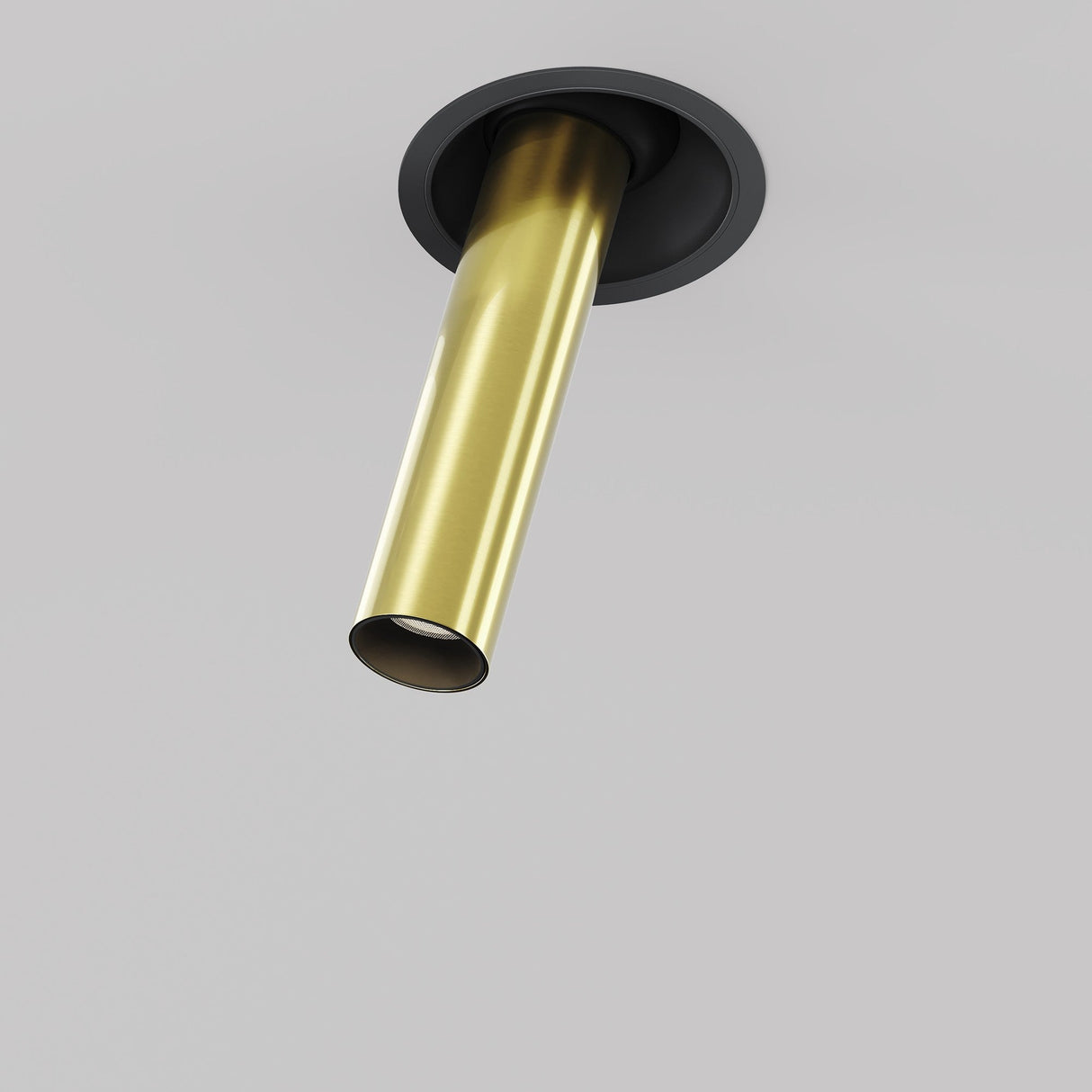 Close-up of the Focus T LED Adjustable Downlight: a minimalist black & brass fixture with a cylindrical tube extending from a round black base, set against a light gray background.