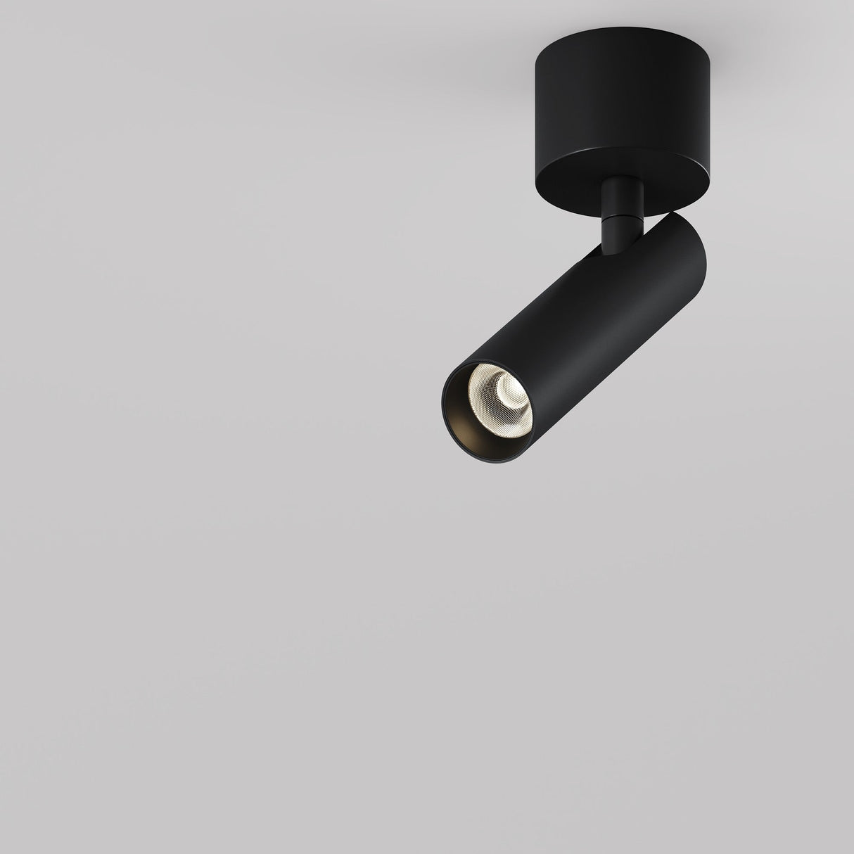 Against a plain white background, the Focus T LED Short Single Spotlight 6W 3000K - Black is mounted, showcasing its minimalist black cylindrical design and offering energy-efficient illumination with its LED spotlight.