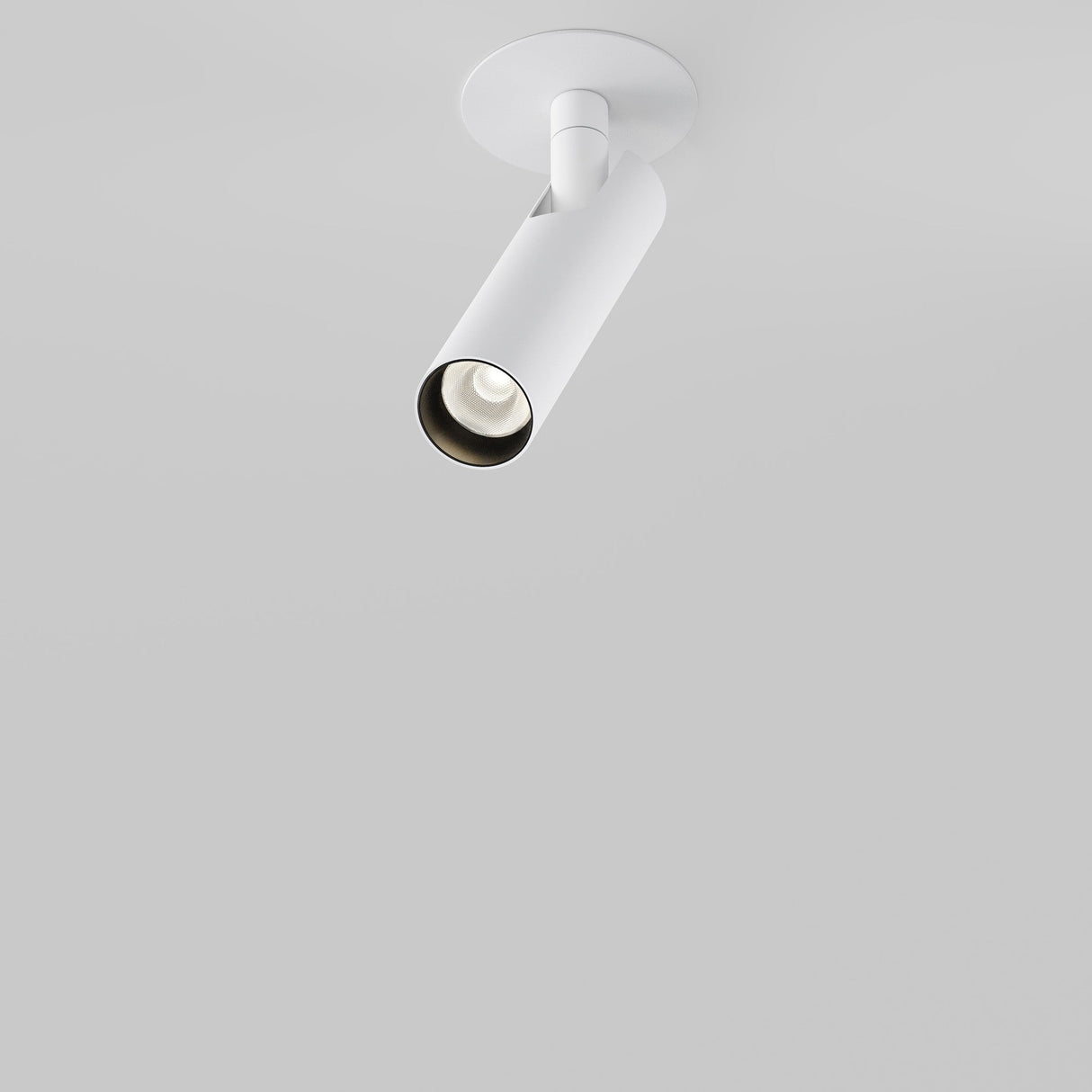 The Focus T LED Adjustable Short Recessed Downlight 6W 3000K in white, a minimalist cylindrical spotlight, is ceiling-mounted against a plain white background. Its sleek design offers energy-efficient lighting and a clean, modern aesthetic.