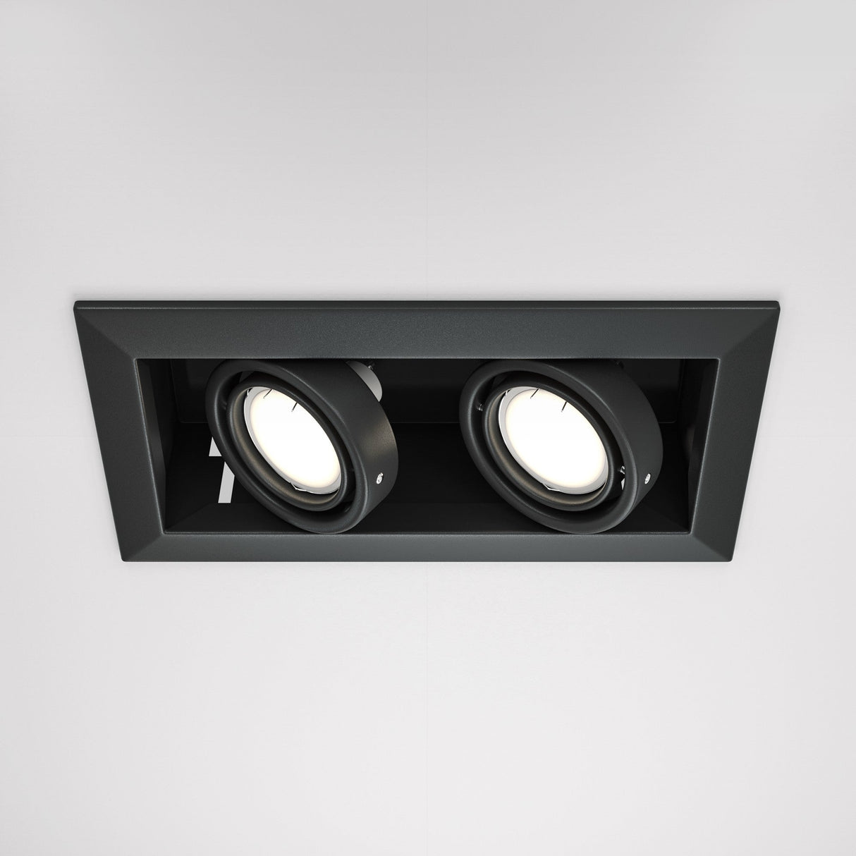 The Metal Modern Twin Tilt Rectangular Recessed Downlight - Black offers an elegant lighting solution with two adjustable round spotlights set in a sleek black frame against a white ceiling.