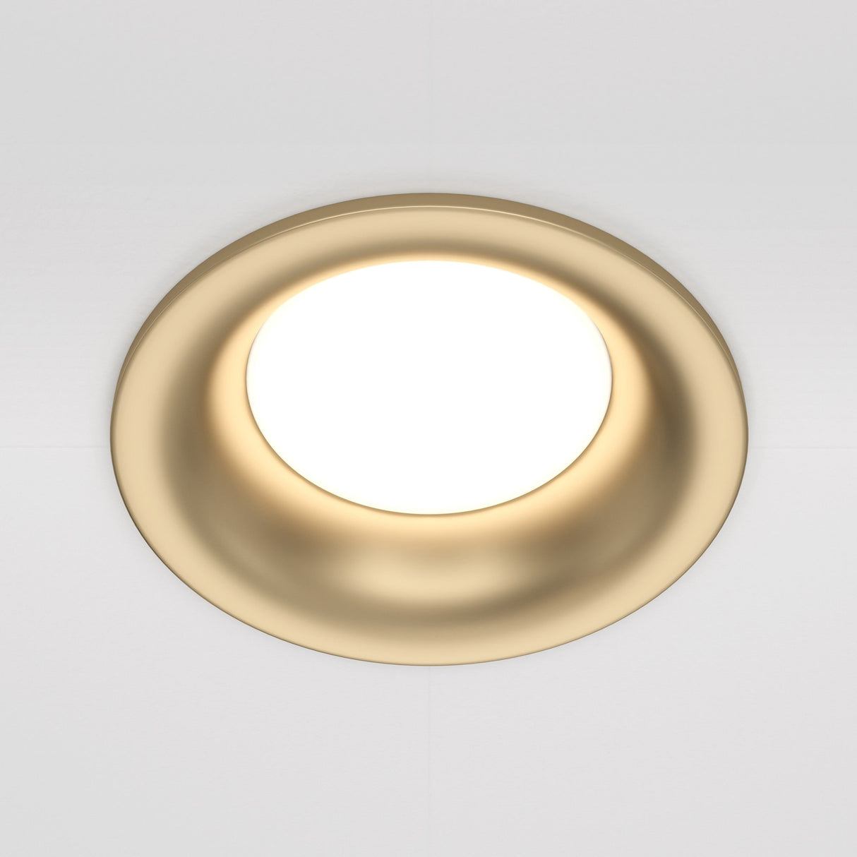 The Slim Fixed Round Recessed Downlight, in matte gold, offers a modern look with a circular design featuring a smooth rim and bright center. Its elegant simplicity is highlighted against the clean backdrop of a white ceiling.
