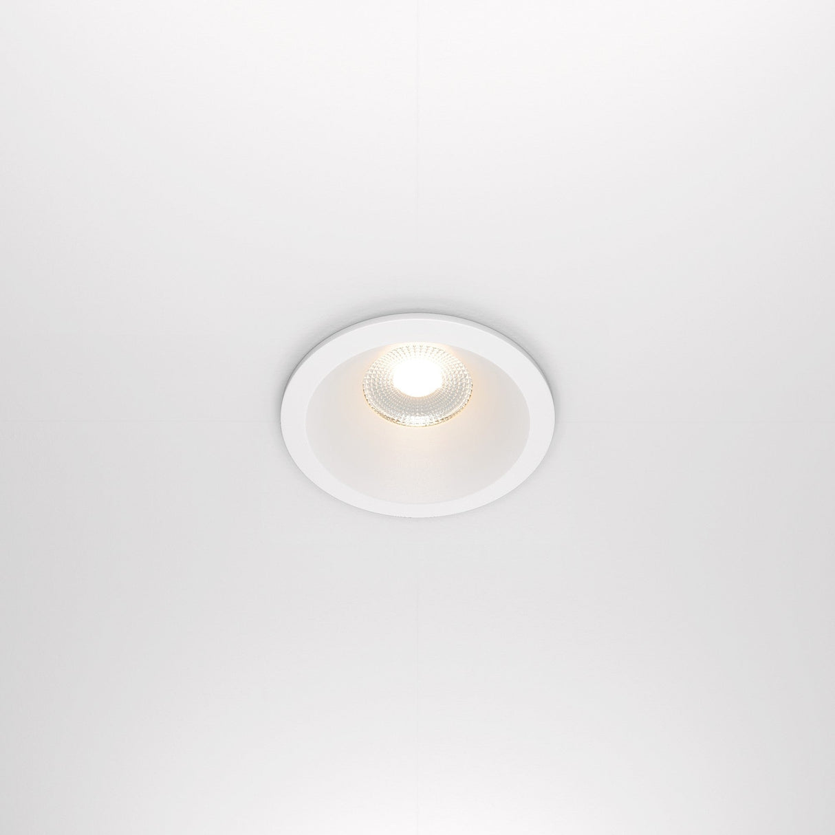 The Zoom LED Dimmable Round Recessed Downlight 12W 3000K in white casts a bright, circular glow on the ceiling, offering soft, even illumination.