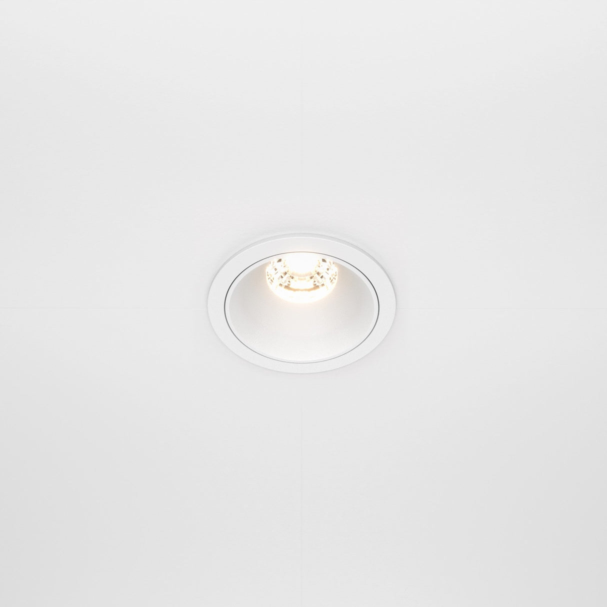 The Alfa LED Dimmable Fixed Round Recessed Downlight 10W 3000K in white casts a subtle glow on a smooth white ceiling.