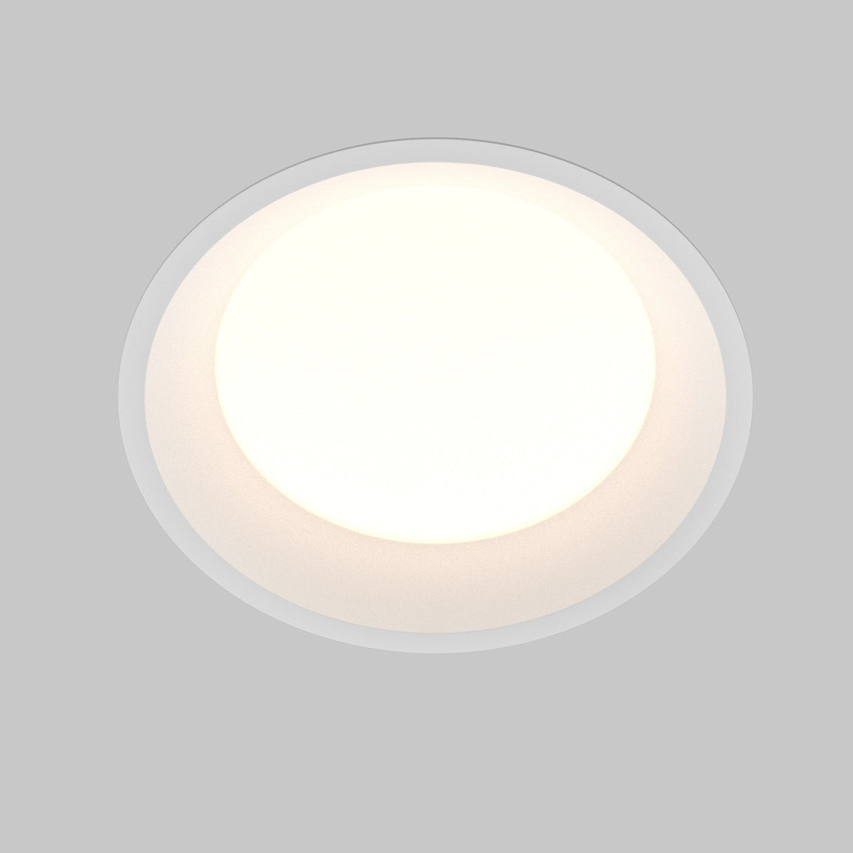 The Okno CCT LED Round Recessed Downlight 24W, with an adjustable color temperature of 3000-6000K, delivers energy-efficient soft white light against a light gray backdrop for customizable ambiance.