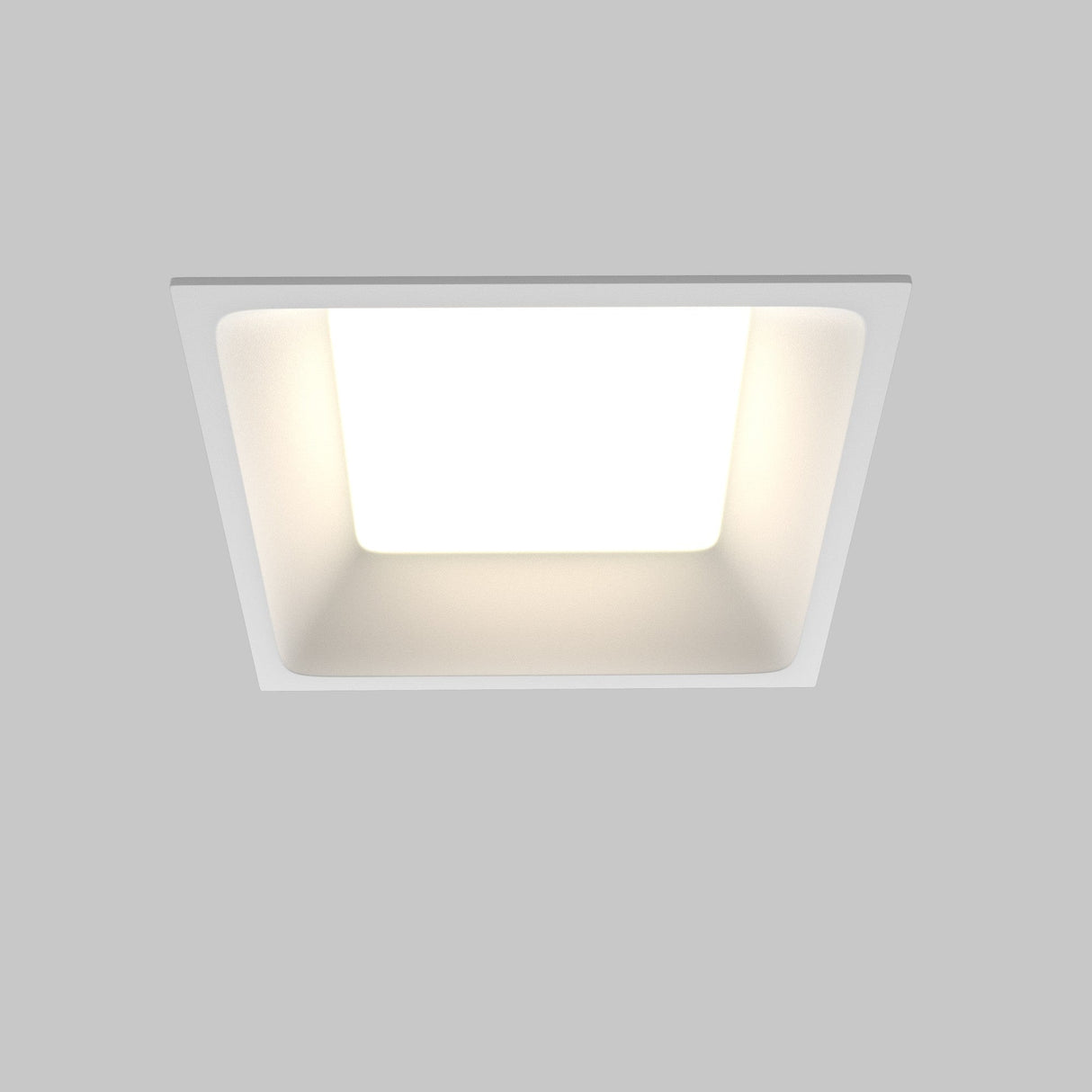 The Okno CCT LED Square Recessed Downlight 12W 3000-6000K in white emits a bright, even glow. With a minimalist design against a gray background, this energy-efficient fixture allows for adjustable color temperature to create customized ambiance.
