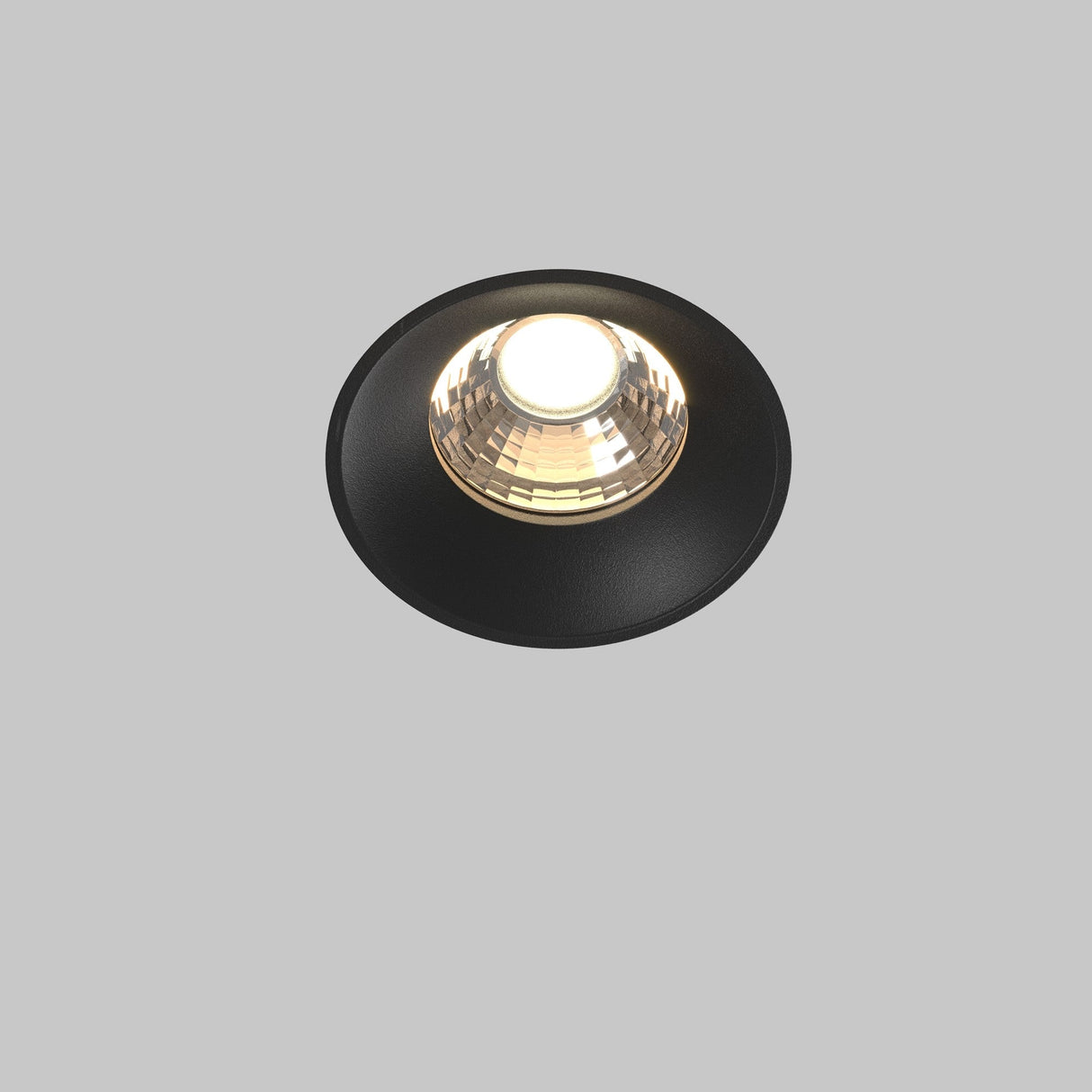 A Round LED Recessed Trimless Downlight 12W 3000K in black, with a glowing bulb at its center, is mounted against a white background, seamlessly blending into the modern interior design.