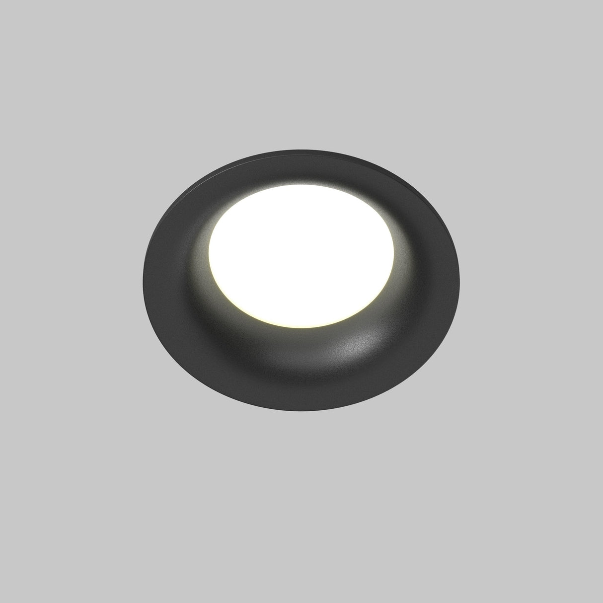 The Slim Outdoor Fixed Round Recessed Downlight - Black features a minimalist design with bright LED lighting, seamlessly blending style and functionality against a light grey background.