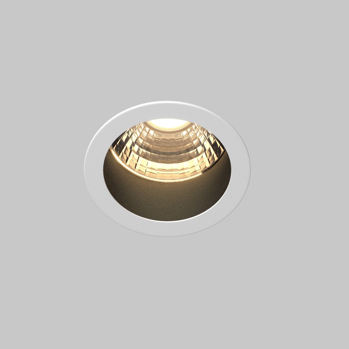 The Minor LED Recessed Downlight 5W 3000K with white trim and reflective inside provides warm, energy-efficient lighting against a plain gray backdrop.