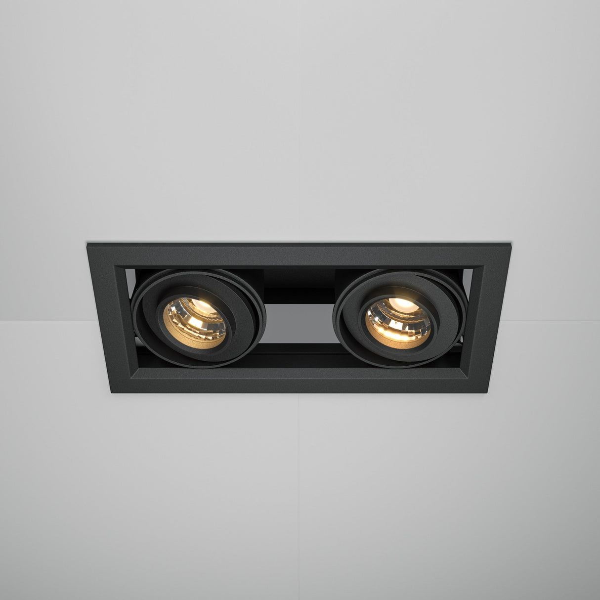 The Metal Modern LED Rectangular Recessed Twin Downlight 20W 3000K in black features two adjustable spotlights that emit energy-efficient LED lighting, creating a warm ambiance that contrasts beautifully against the white ceiling.