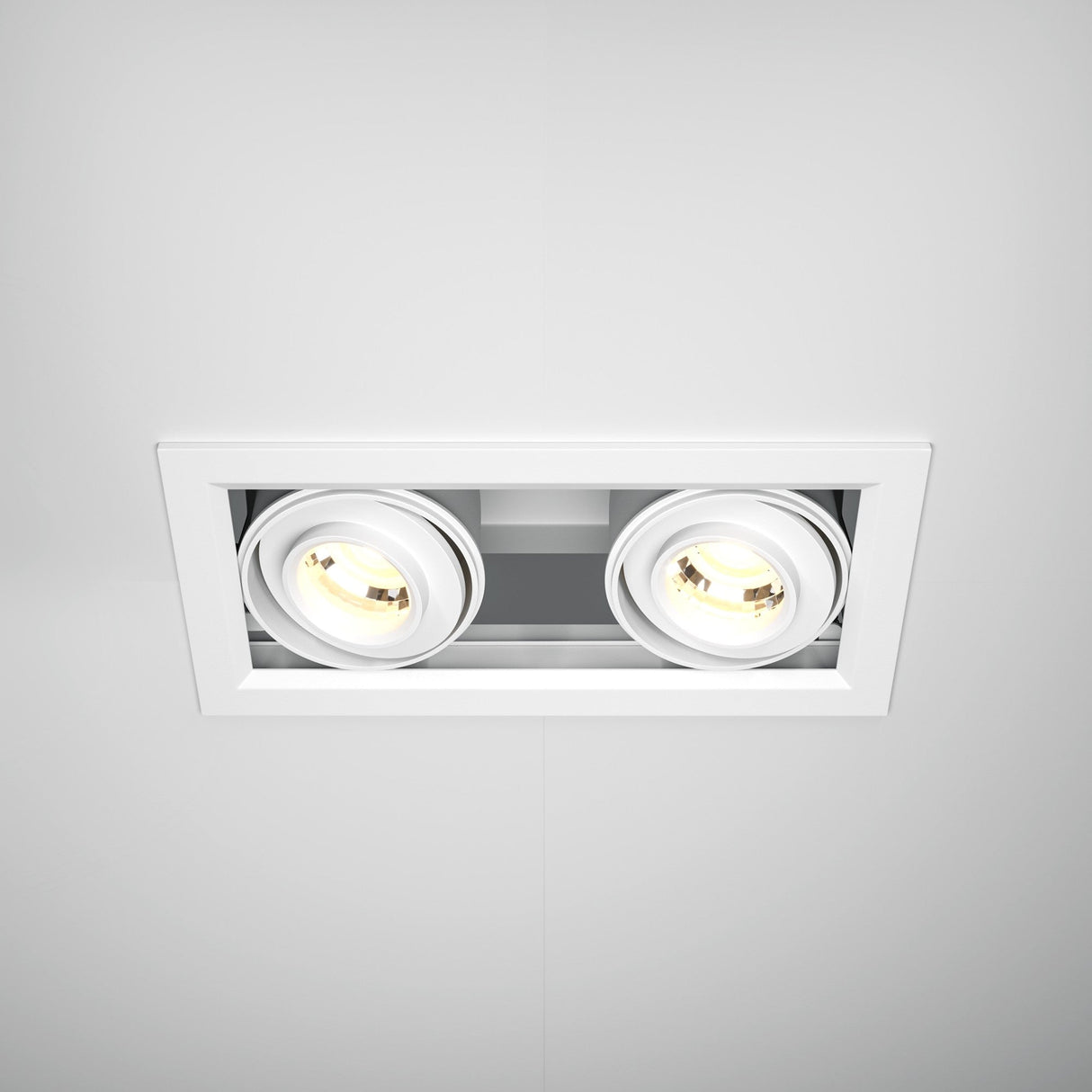 A close-up of the Metal Modern LED Rectangular Recessed Twin Downlight 20W 3000K - White, featuring a dual circular bulb design. The seamless rectangular fit enhances efficiency while emitting a soft yellowish light.
