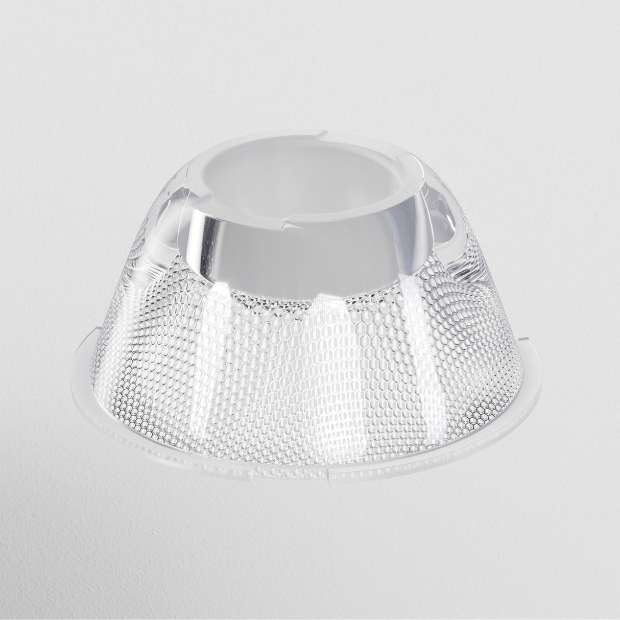 The Focus LED Track Light Lens ⌀43mm 24° features a clear, textured dome with a circular opening, set against a plain white background. Its honeycomb pattern beautifully reflects light, ideal for accent lighting or use as an LED track light lens.