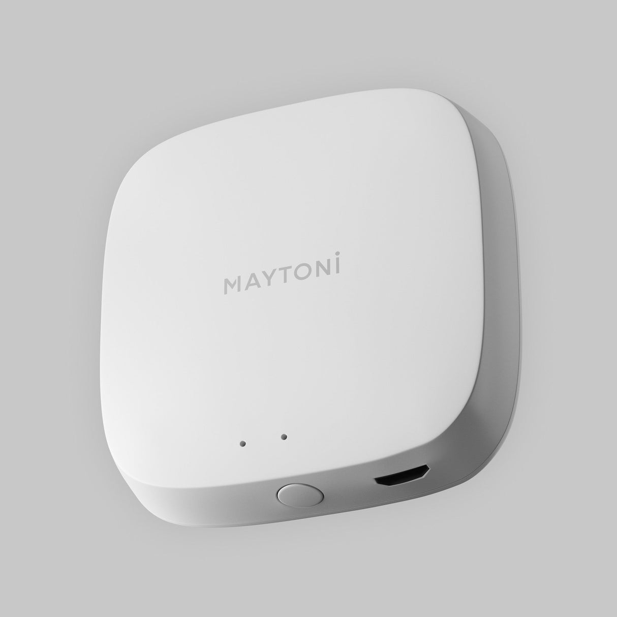 The Smart Home Control Wi-Fi Module by Maytoni is a white, square-shaped device with rounded edges, a front button, two indicator lights, and a port. Its minimalist design suits smart home setups perfectly and stands out against a light gray background.