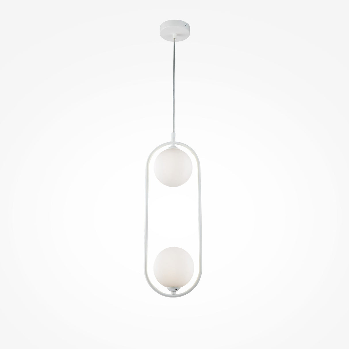 The Ring 2 Light Pendant features a sleek, modern design with two white glass spheres in a vertical oval frame, offering versatile ambient light. It hangs from a thin cord and attaches to a round ceiling mount, all in pristine white.