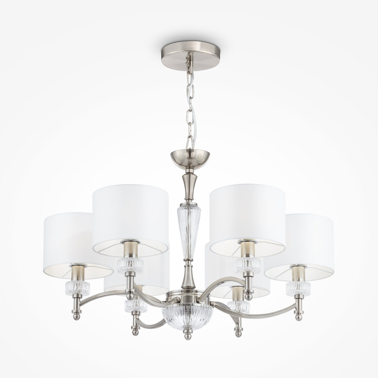 The Alicante 6 Light Chandelier - Nickel boasts five white fabric shades, elegant curved arms, and clear glass accents. Its sleek nickel finish and graceful chain mount make it ideal for modern interiors as a stylish lighting solution.