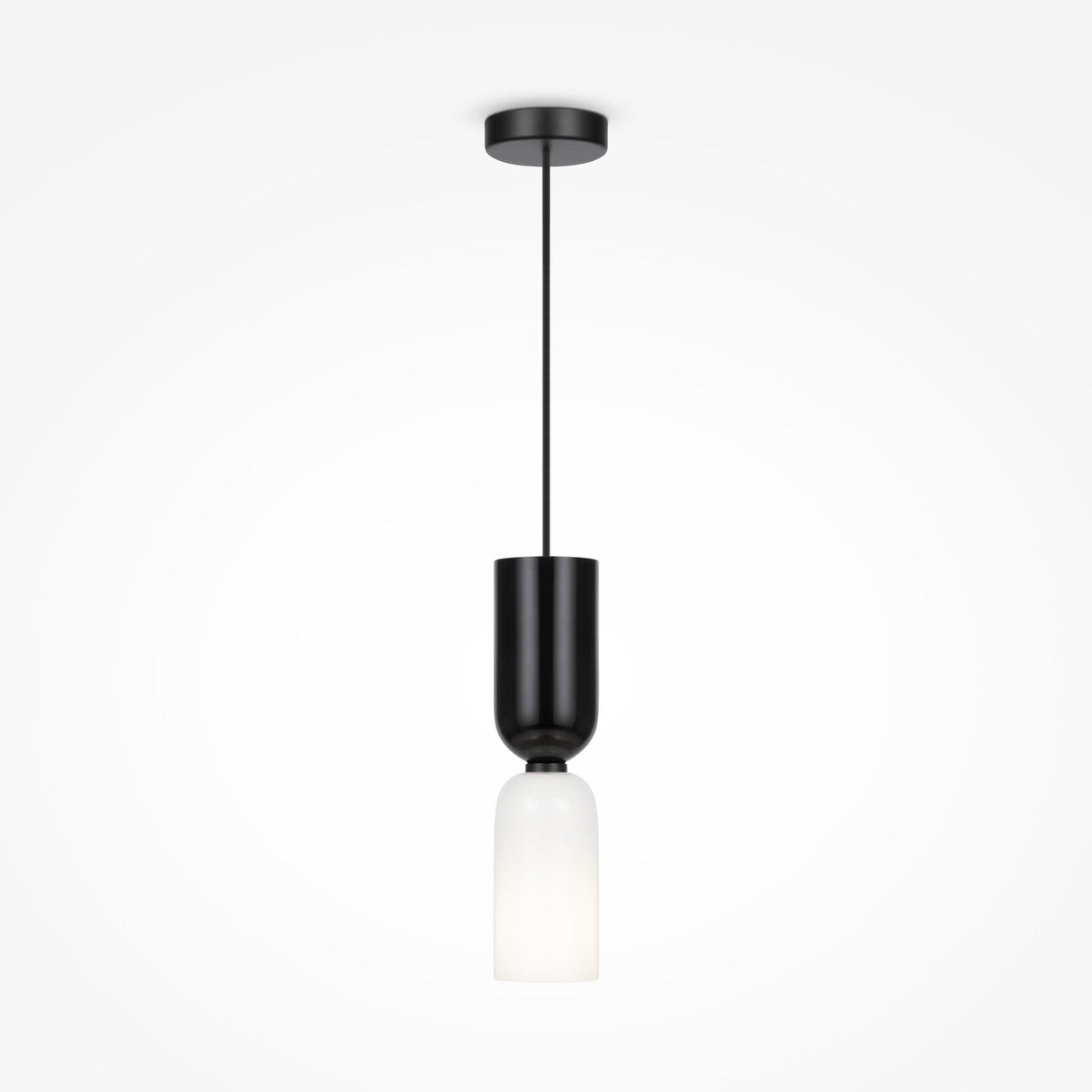The Memory Hourglass Pendant Light features a black cylindrical fixture with a white frosted glass shade, hanging elegantly from a thin black wire and round ceiling mount, making it an ideal addition to modern interiors for ambient lighting against plain white backdrops.