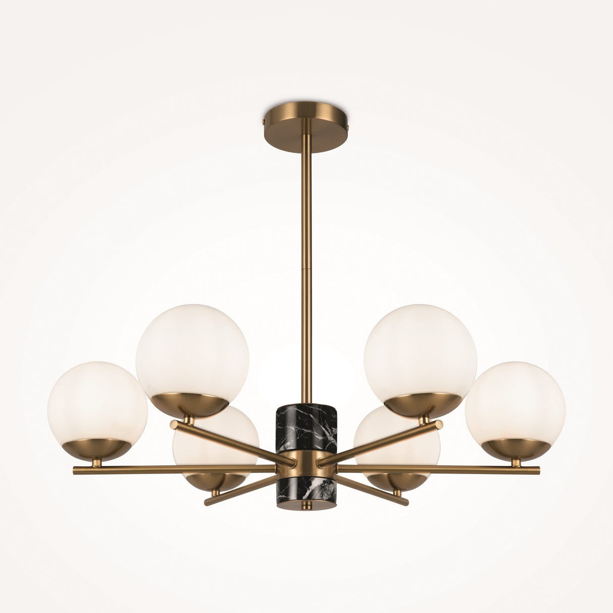The Marble 6 Light Chandelier - Brass showcases a central black marble accent, six opal glass globes on gold metal arms, and is elegantly suspended from a brass frame and ceiling mount. It skillfully merges modern and classic design elements.