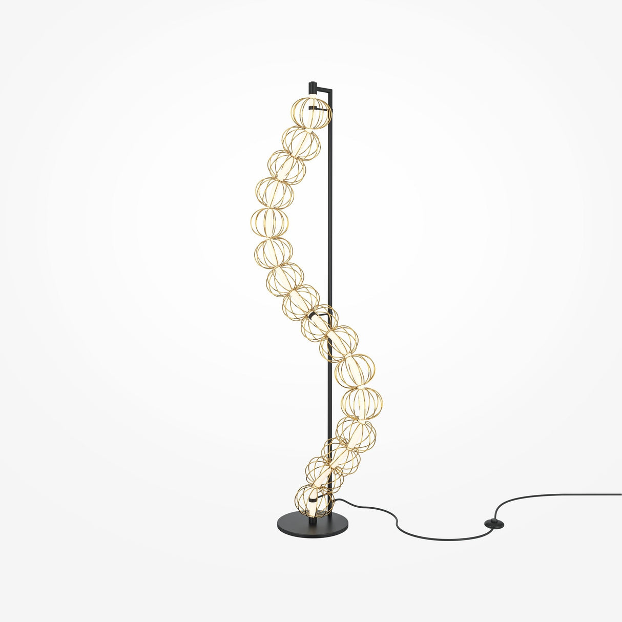 The Golden Cage Floor Lamp - Gold features decorative handmade wire spheres on a sleek black base. It provides warm, energy-efficient lighting from a twisting column of spherical lights, plugged in with a long black cord against a white backdrop.