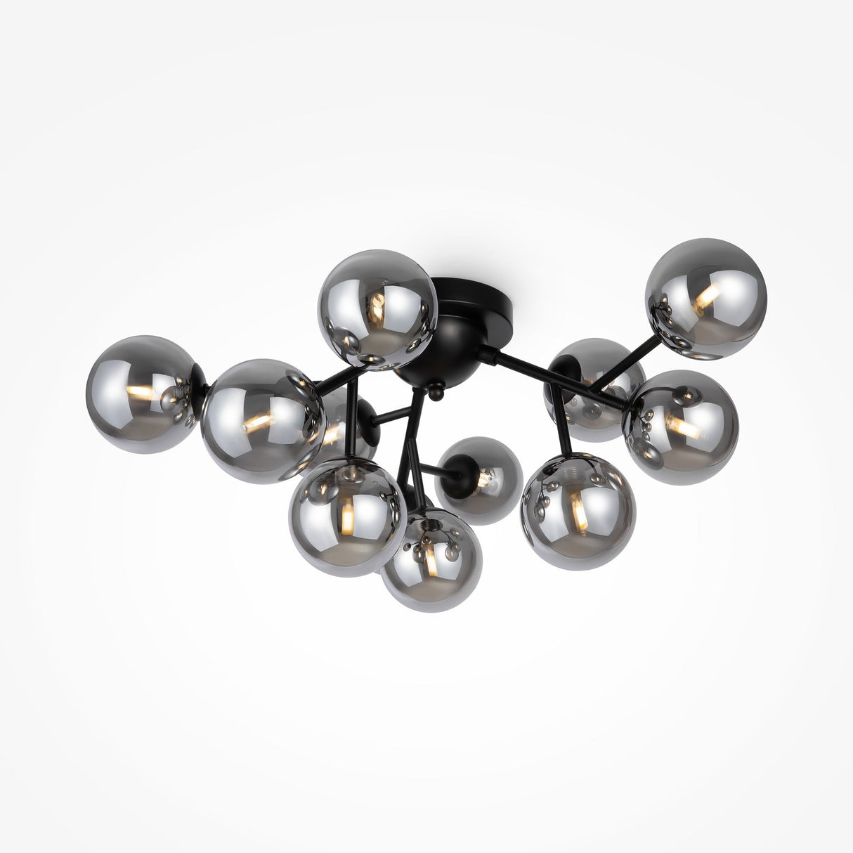 The Dallas 12 Light Semi-Flush fixture features an industrial design with black branching arms and smoked glass. Its contemporary look is enhanced by twelve spherical bulbs creating a clustered effect, each showcasing visible filaments against a contrasting background.
