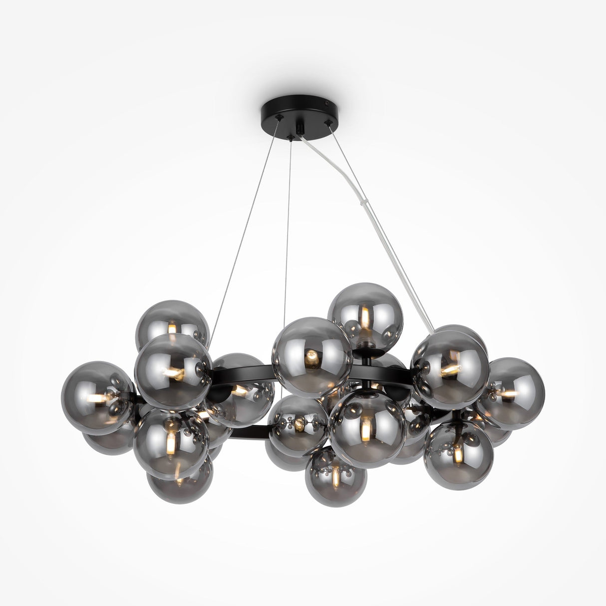 The Dallas 25 Light Suspension is a sleek modern design with multiple smoky glass globes on thin metal cables, suspended from a circular black ceiling mount, each globe housing a bulb.