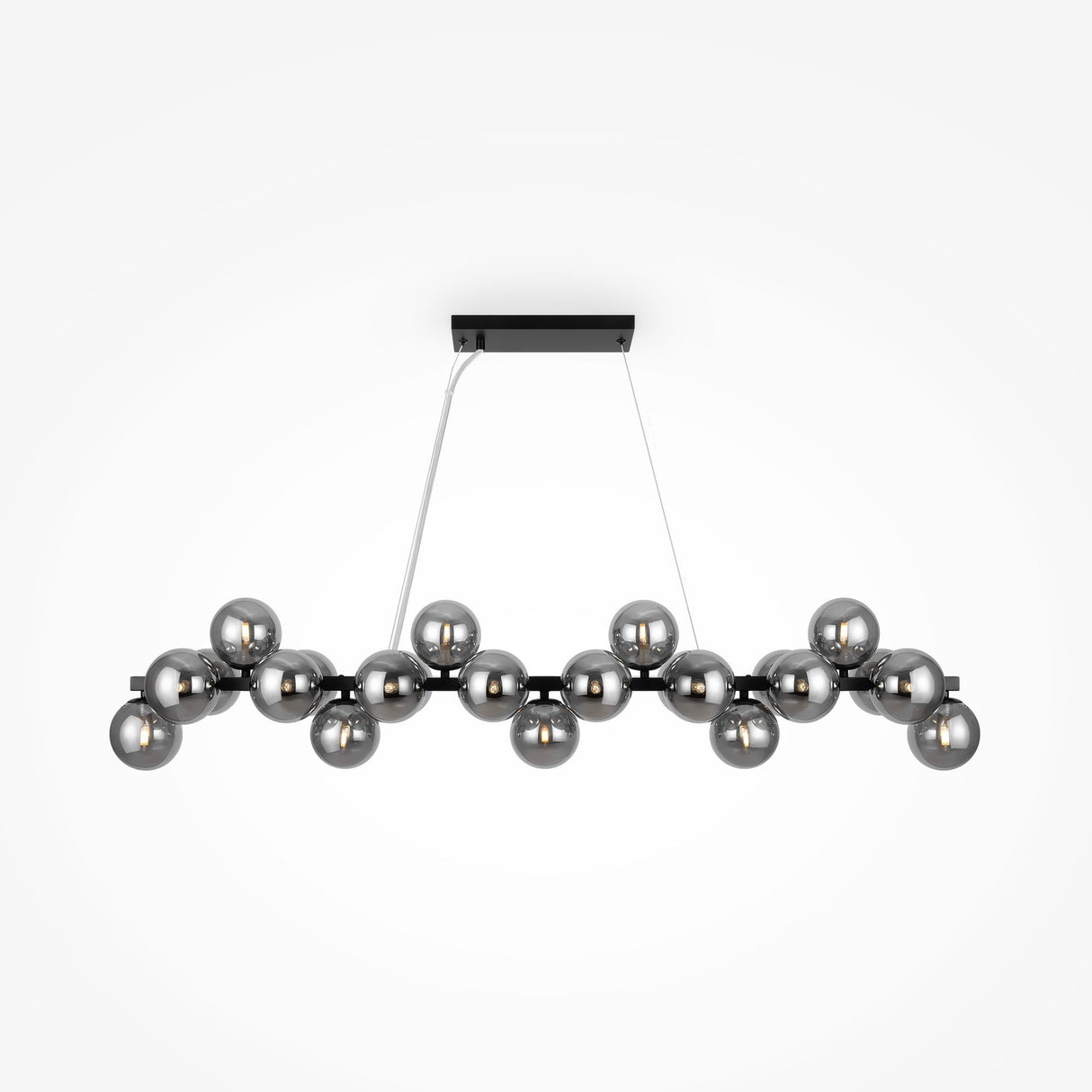 The Dallas 25 Light Linear Suspension in black with smoked glass features a sleek modern design. It has a rectangular base with 18 metallic spherical bulbs in two parallel rows, supported by thin cables, and elegantly complements a plain white background.