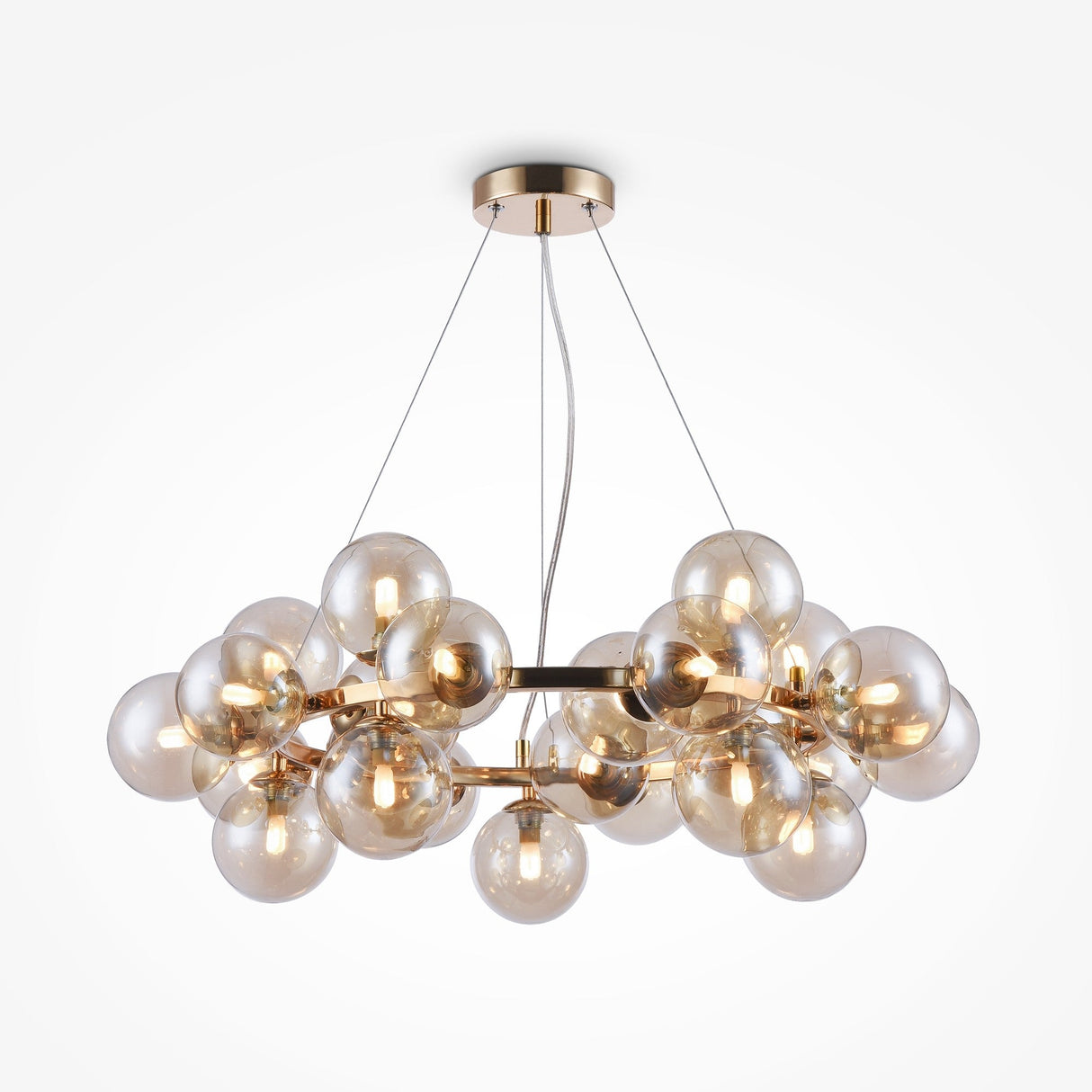 The Dallas 25 Light Suspension features a gold metal circular frame with spherical amber glass bulbs. Suspended by thin cables, it casts a warm glow in any space.