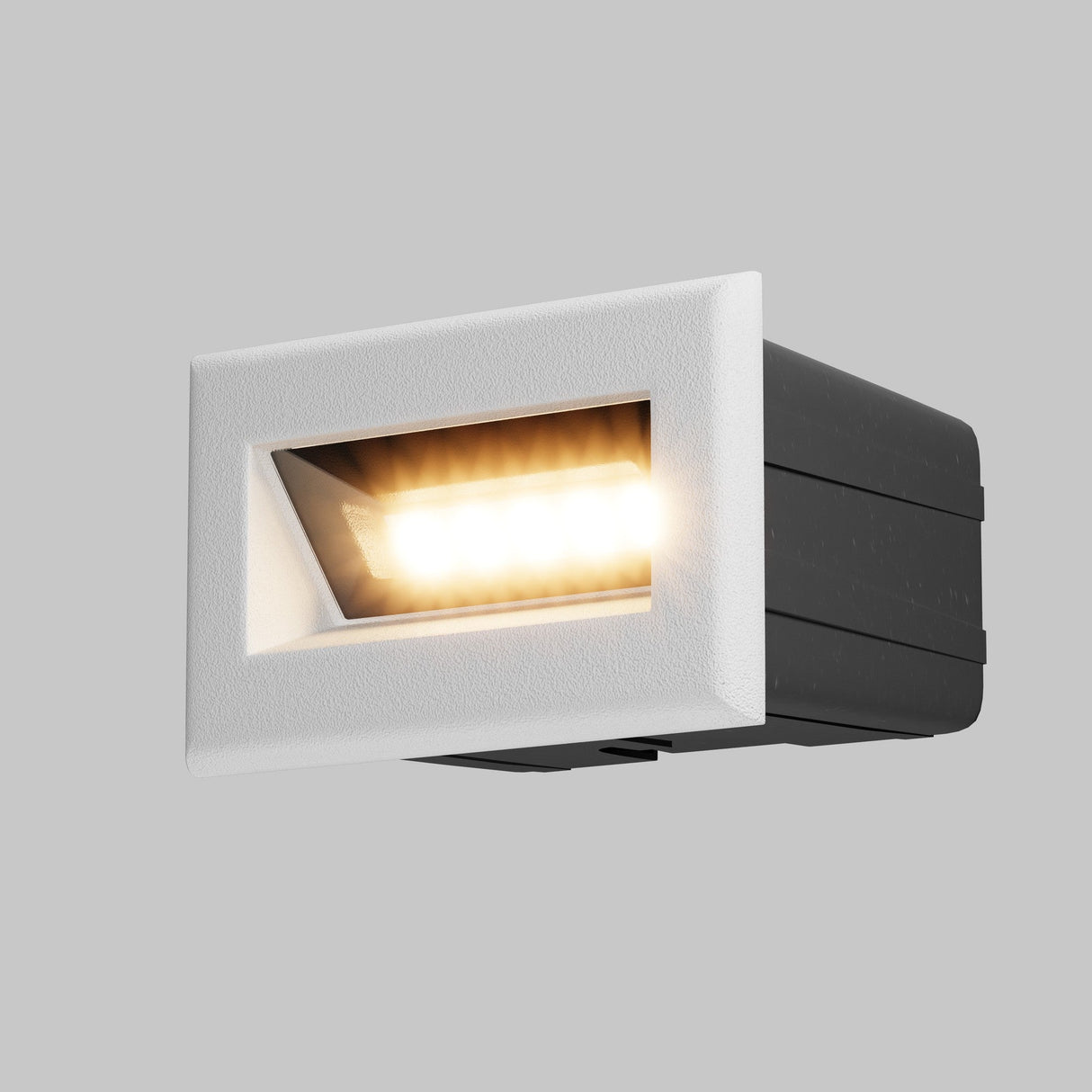 The Bosca Outdoor LED Recessed Wall Light combines modern elegance with its white frame and black housing, casting warm white light at an angle against a gray background to enhance any space with energy-efficient sophistication.