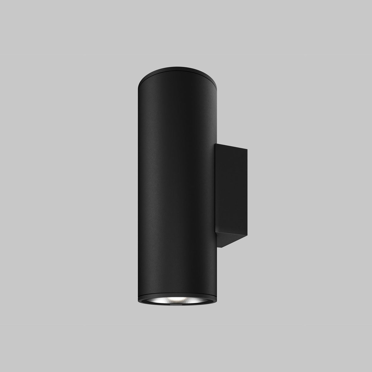 The Shim Outdoor Wall Light 24W 3000K - Graphite, with a sleek black cylindrical design and a modern, minimalistic style, is set against a gray background. It features a downward-facing light source.