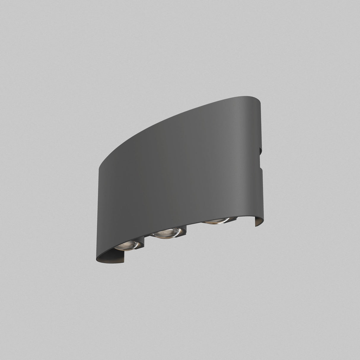 The Strato Outdoor LED Wall Light 6W 3000K in grey boasts a sleek, curved design with a dark finish and three visible round lights. Made from corrosion-resistant materials, it casts light up and down, ideal for outdoor use against a light gray wall.