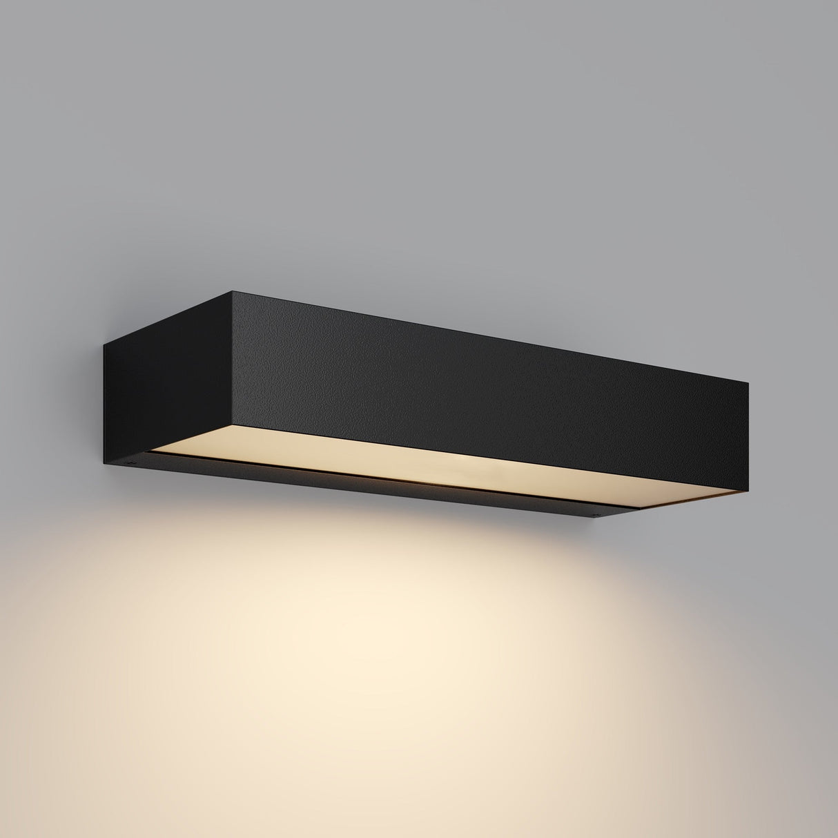 The Lot Outdoor LED Wall Light 10W 3000K in graphite features a modern rectangular design that casts a soft, warm glow against grey walls. Its minimalist style with clean lines and corrosion-resistant materials delivers a contemporary aesthetic.