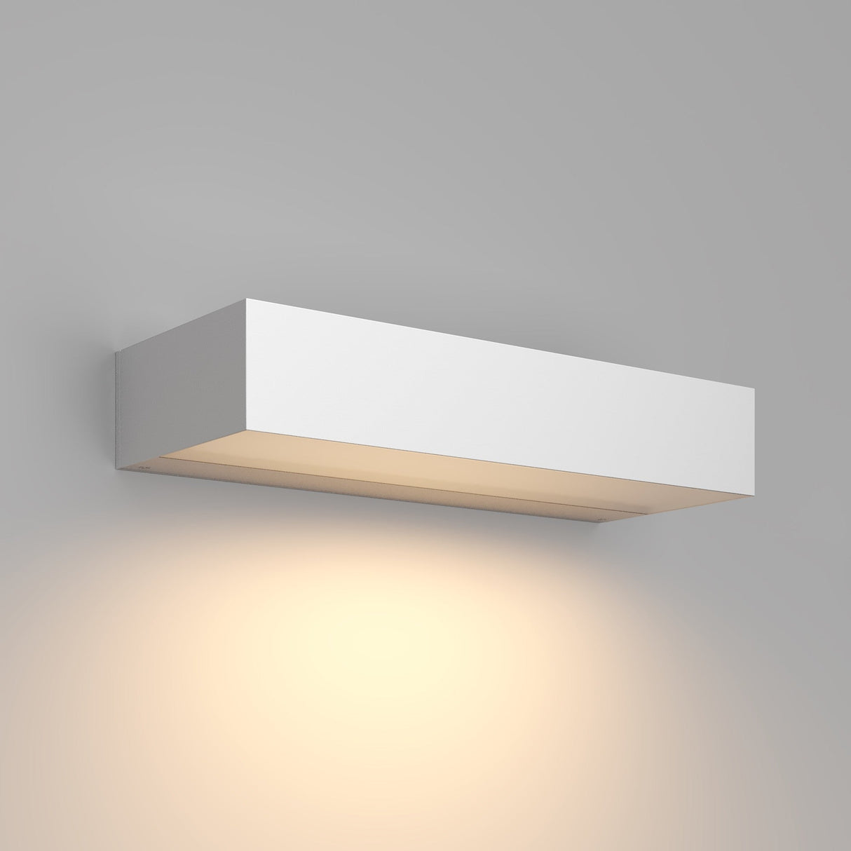 The Lot Outdoor LED Wall Light 10W 3000K - White is a modern, rectangular fixture mounted on a gray wall. Its energy-efficient design emits a warm glow downward, creating subtle ambiance on the surface below.
