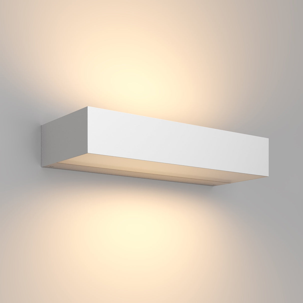 The Lot Outdoor LED Wall Light, 20W 3000K in white, features a rectangular design and high IP65 rating. It softly illuminates both upward and downward on a light gray wall, creating a subtle gradient effect. This energy-efficient fixture enhances any space effortlessly.